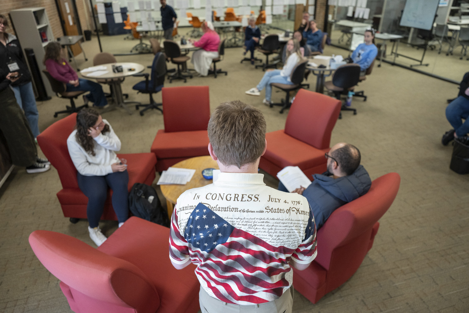 man wearing Constitution shirt with back to camera
